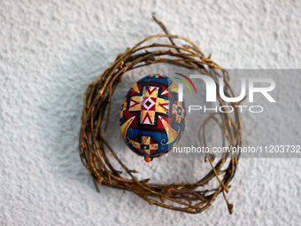 A Ukrainian Easter egg, known as the pysanka, is being surrounded by a wreath made of twigs in Rynok Square ahead of Orthodox Easter on May...