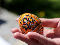 A woman is holding a Ukrainian Easter egg, known as the pysanka, in Rynok Square ahead of Orthodox Easter on May 5, in Ivano-Frankivsk, Ukra...