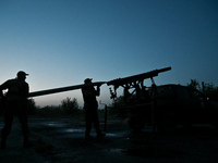 Servicemen of the Steppe Wolves all-volunteer unit are loading Grad rocket launch tubes that they captured from Russian troops and a sightin...