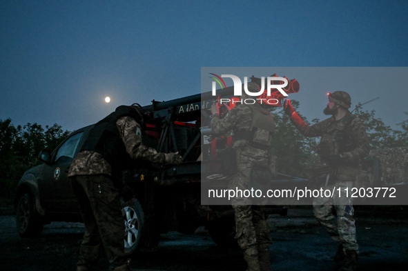 Servicemen of the Steppe Wolves all-volunteer unit are operating Grad rocket launch tubes that they captured from Russian troops and a sight...