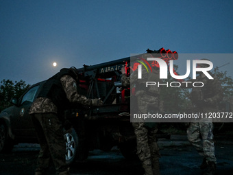 Servicemen of the Steppe Wolves all-volunteer unit are operating Grad rocket launch tubes that they captured from Russian troops and a sight...