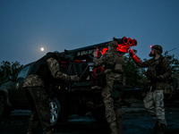 Servicemen of the Steppe Wolves all-volunteer unit are operating Grad rocket launch tubes that they captured from Russian troops and a sight...