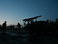 Servicemen of the Steppe Wolves all-volunteer unit are loading Grad rocket launch tubes, which were captured from Russian troops, and a sigh...