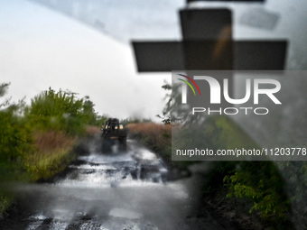 A pickup truck belonging to the Steppe Wolves all-volunteer unit is traveling on the road in Zaporizhzhia Region, southeastern Ukraine, on A...