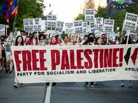 Workers and supporters of a ceasefire in Gaza demonstrate on International Workers’ Day, Washington, DC, May 1, 2024.  Speakers from a varie...