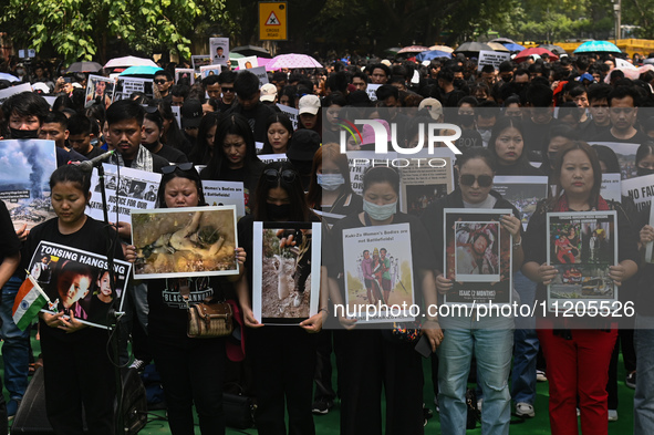 Members of the Kuki-Zo community are holding placards in a protest against the violent clashes that began last year on May 3, 2023, between...