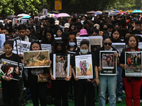 Members of the Kuki-Zo community are holding placards in a protest against the violent clashes that began last year on May 3, 2023, between...