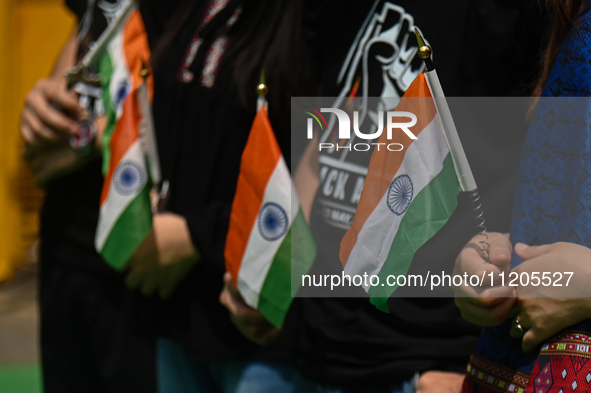 Members of the Kuki-Zo community are holding Indian national flags during a protest against the violent clashes that began last year on May...