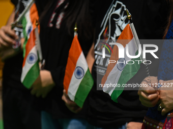 Members of the Kuki-Zo community are holding Indian national flags during a protest against the violent clashes that began last year on May...