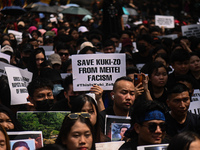 Members of the Kuki-Zo community are holding placards in a protest against the violent clashes that began last year on May 3, 2023, between...