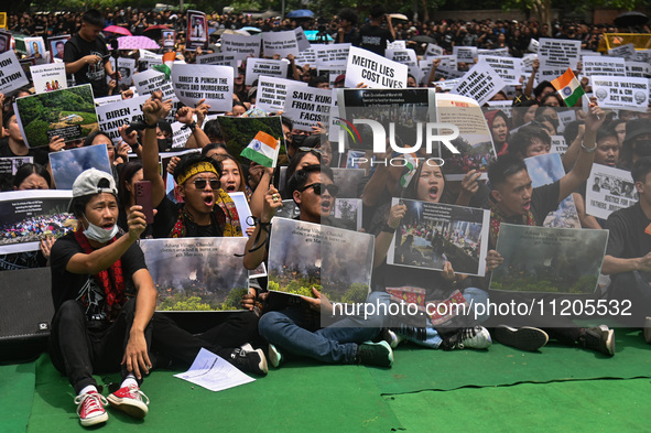 Members of the Kuki-Zo community are holding placards and shouting slogans in a protest against the violent clashes that began last year bet...