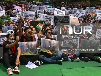 Members of the Kuki-Zo community are holding placards and shouting slogans in a protest against the violent clashes that began last year bet...