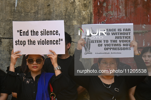 Members of the Kuki-Zo community are holding placards in a protest against the violent clashes that began last year on May 3, 2023, between...