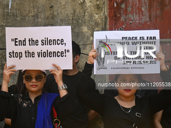 Members of the Kuki-Zo community are holding placards in a protest against the violent clashes that began last year on May 3, 2023, between...