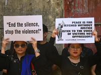 Members of the Kuki-Zo community are holding placards in a protest against the violent clashes that began last year on May 3, 2023, between...