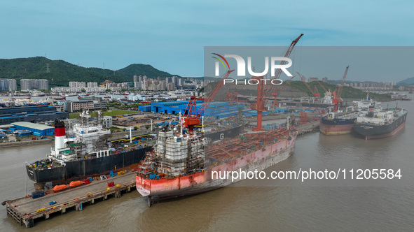 Workers are repairing ships in Zhoushan, China, on May 3, 2024. 