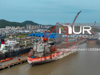 Workers are repairing ships in Zhoushan, China, on May 3, 2024. (