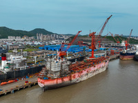 Workers are repairing ships in Zhoushan, China, on May 3, 2024. (