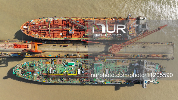 Workers are repairing ships in Zhoushan, China, on May 3, 2024. 