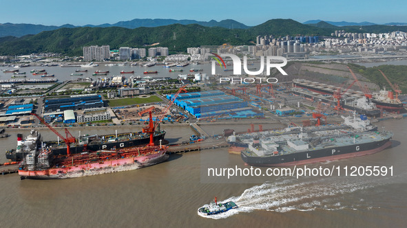 Workers are repairing ships in Zhoushan, China, on May 3, 2024. 