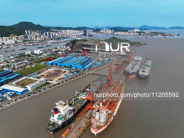 Workers are repairing ships in Zhoushan, China, on May 3, 2024. 