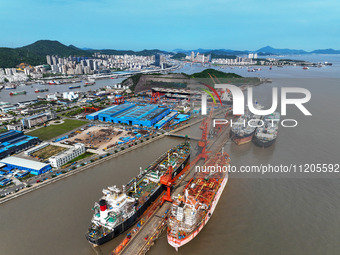 Workers are repairing ships in Zhoushan, China, on May 3, 2024. (