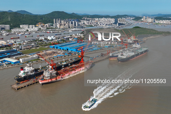 Workers are repairing ships in Zhoushan, China, on May 3, 2024. 