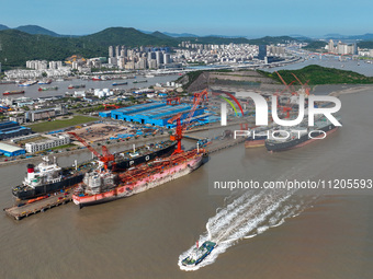 Workers are repairing ships in Zhoushan, China, on May 3, 2024. (