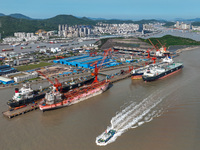 Workers are repairing ships in Zhoushan, China, on May 3, 2024. (