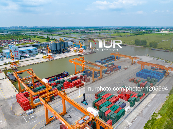 Workers are carrying out loading and unloading operations at the container terminal of Xinghua Port in East China's Jiangsu province, on May...