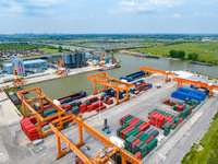 Workers are carrying out loading and unloading operations at the container terminal of Xinghua Port in East China's Jiangsu province, on May...