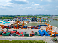 Workers are carrying out loading and unloading operations at the container terminal of Xinghua Port in East China's Jiangsu province, on May...