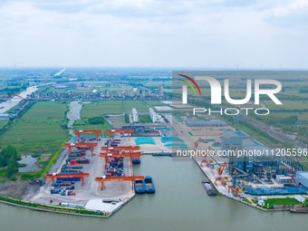 Workers are carrying out loading and unloading operations at the container terminal of Xinghua Port in East China's Jiangsu province, on May...