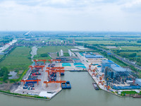 Workers are carrying out loading and unloading operations at the container terminal of Xinghua Port in East China's Jiangsu province, on May...