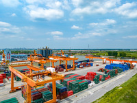 Workers are carrying out loading and unloading operations at the container terminal of Xinghua Port in East China's Jiangsu province, on May...