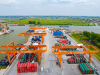 Workers are carrying out loading and unloading operations at the container terminal of Xinghua Port in East China's Jiangsu province, on May...