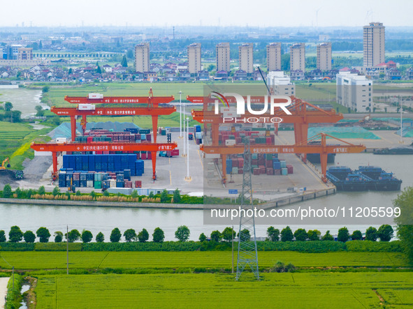 Workers are carrying out loading and unloading operations at the container terminal of Xinghua Port in East China's Jiangsu province, on May...