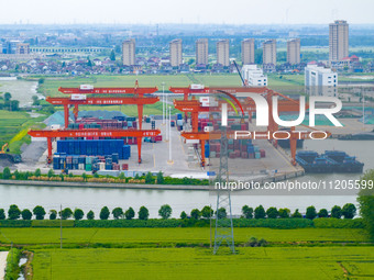 Workers are carrying out loading and unloading operations at the container terminal of Xinghua Port in East China's Jiangsu province, on May...