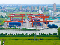 Workers are carrying out loading and unloading operations at the container terminal of Xinghua Port in East China's Jiangsu province, on May...