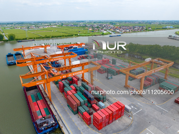 Workers are carrying out loading and unloading operations at the container terminal of Xinghua Port in East China's Jiangsu province, on May...