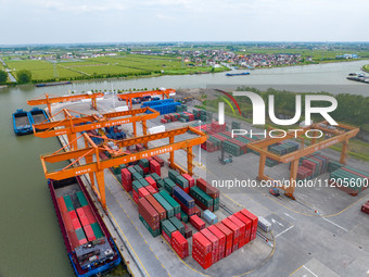 Workers are carrying out loading and unloading operations at the container terminal of Xinghua Port in East China's Jiangsu province, on May...