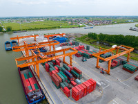 Workers are carrying out loading and unloading operations at the container terminal of Xinghua Port in East China's Jiangsu province, on May...