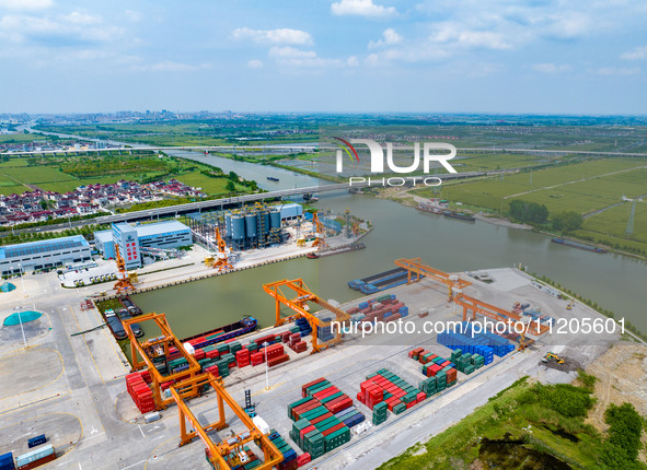 Workers are carrying out loading and unloading operations at the container terminal of Xinghua Port in East China's Jiangsu province, on May...