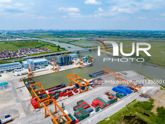 Workers are carrying out loading and unloading operations at the container terminal of Xinghua Port in East China's Jiangsu province, on May...