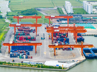 Workers are carrying out loading and unloading operations at the container terminal of Xinghua Port in East China's Jiangsu province, on May...