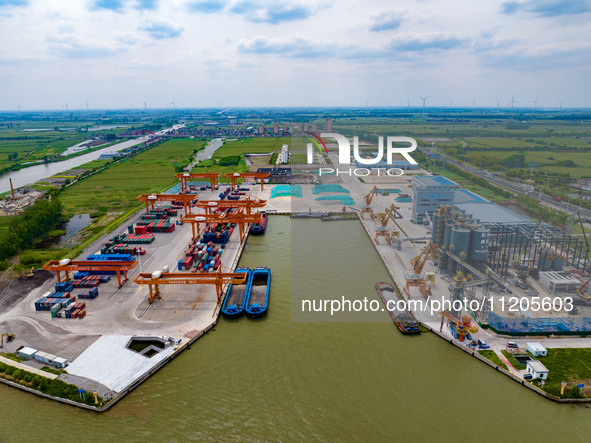 Workers are carrying out loading and unloading operations at the container terminal of Xinghua Port in East China's Jiangsu province, on May...