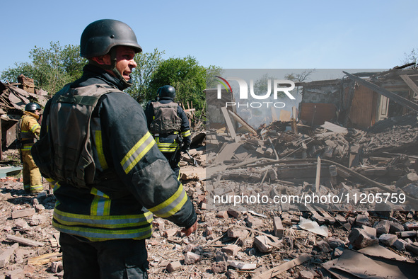 Firefighters are at the scene, in Kharkiv, Ukraine, on May 3, 2024 after the russian aerial bomb attack in Kharkiv.  