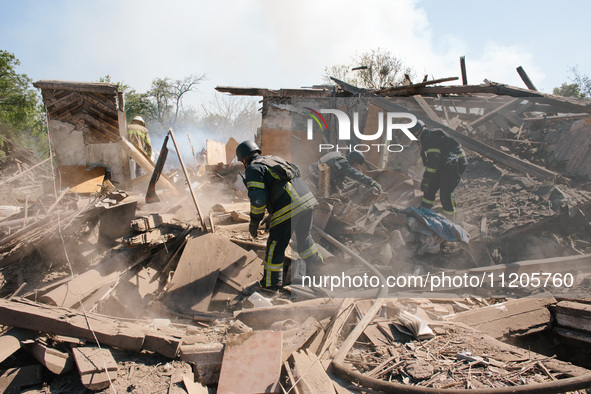 Firefighters are at the scene, in Kharkiv, Ukraine, on May 3, 2024 after the russian aerial bomb attack in Kharkiv.  