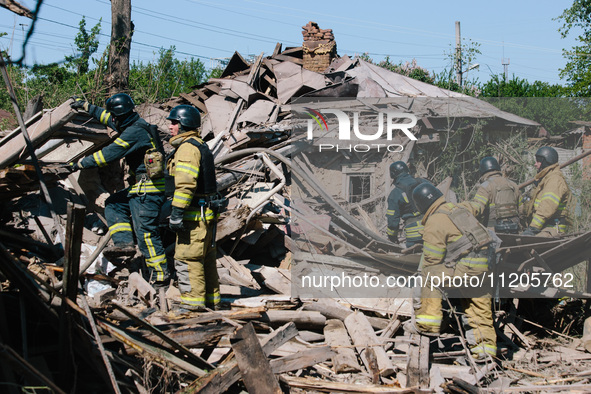 Firefighters are at the scene, in Kharkiv, Ukraine, on May 3, 2024 after the russian aerial bomb attack in Kharkiv.  