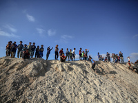 Children are looking on as people attend a mass wedding ceremony in Khan Yunis, in the southern Gaza Strip, on May 3, 2024, amid the ongoing...